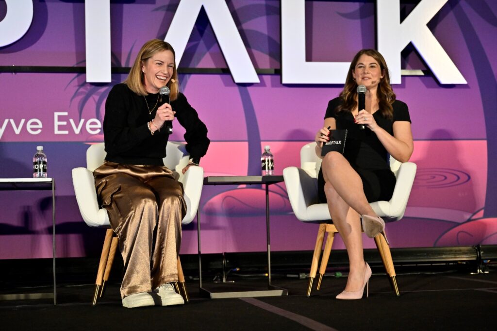 Two women sitting in chairs with microphones Description automatically generated